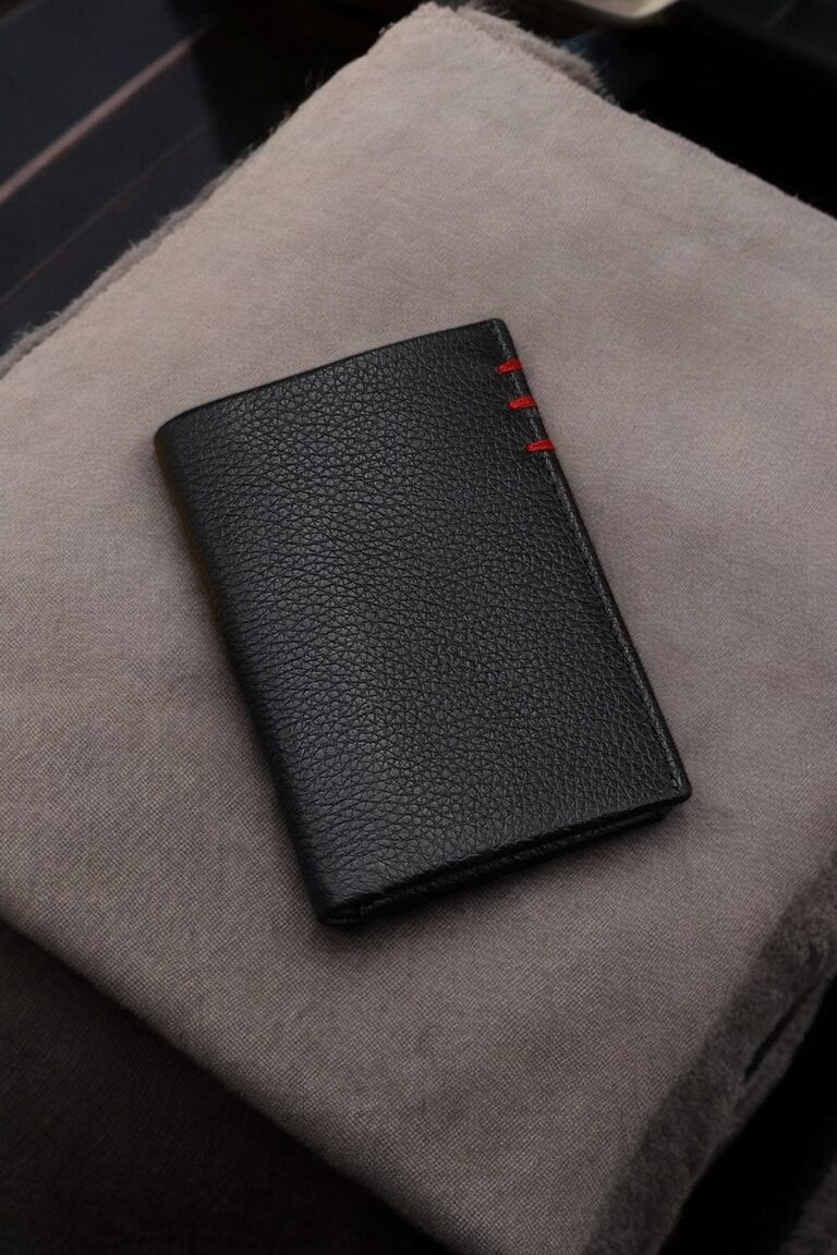 Premium black leather wallet with bold red stitching, front view highlighting its sleek and modern design.